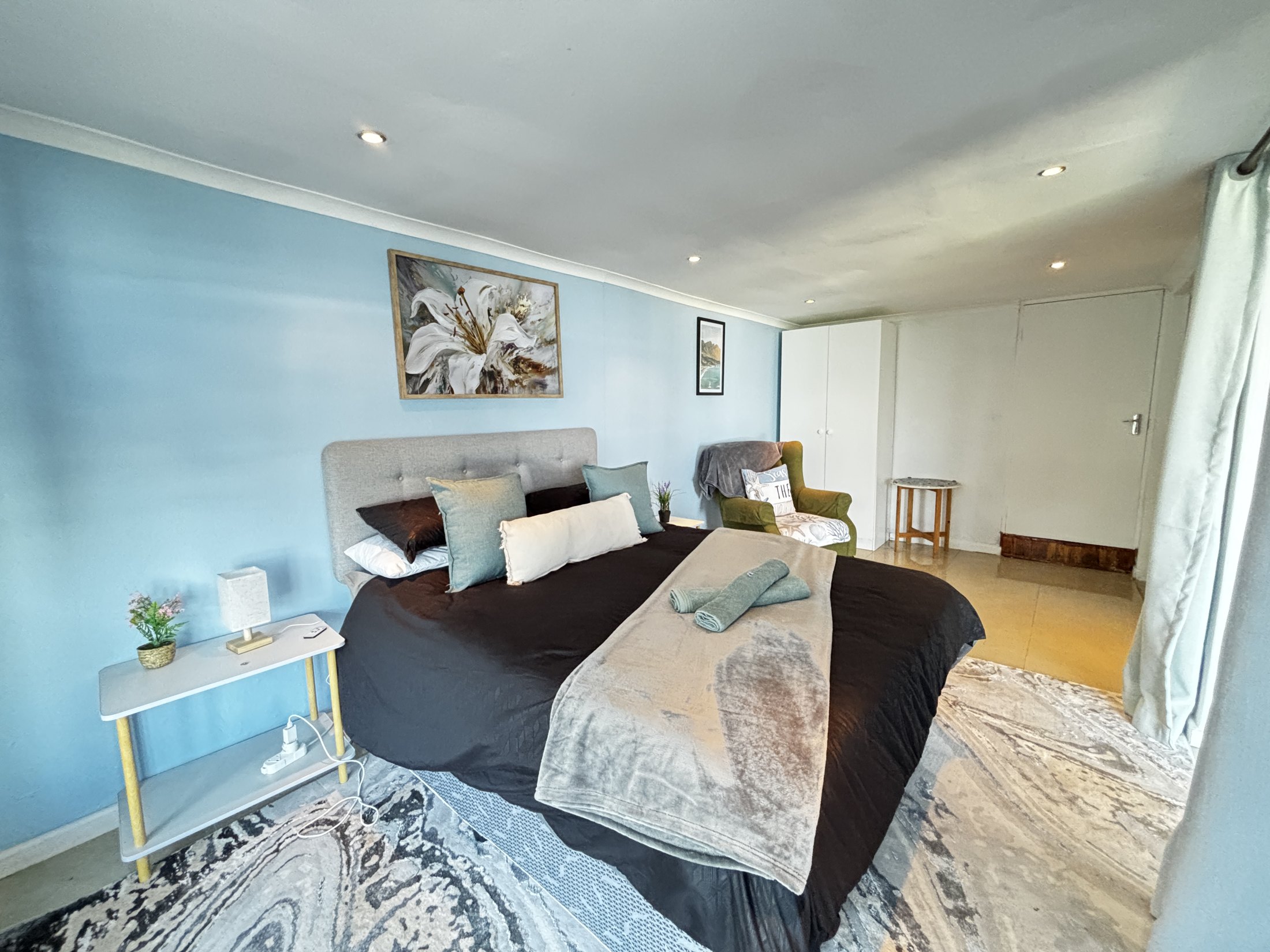 Main bedroom with blue feature wall at Seaview Sunsets in Room 2
