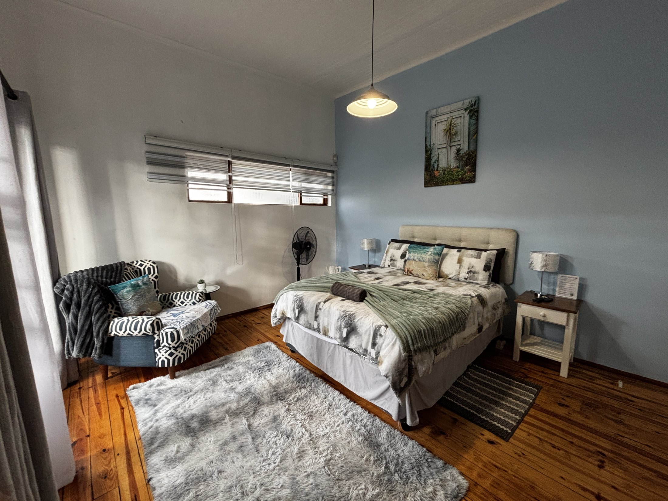 Double bedroom with seating at Seaview Sunsets in Room 4