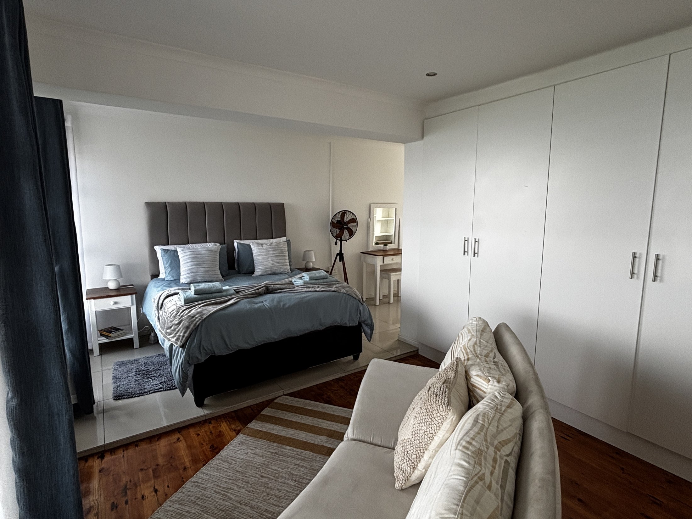 Main bedroom with seating at Seaview Sunsets in Room 6